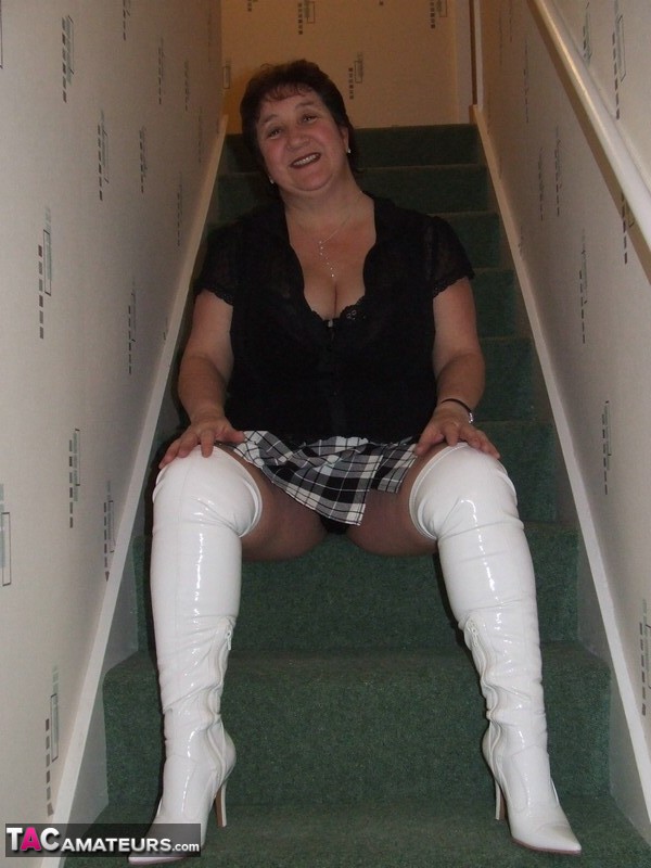 Mature BBW Kinky Carol gets naked in her underthings and OTK boots on stairs