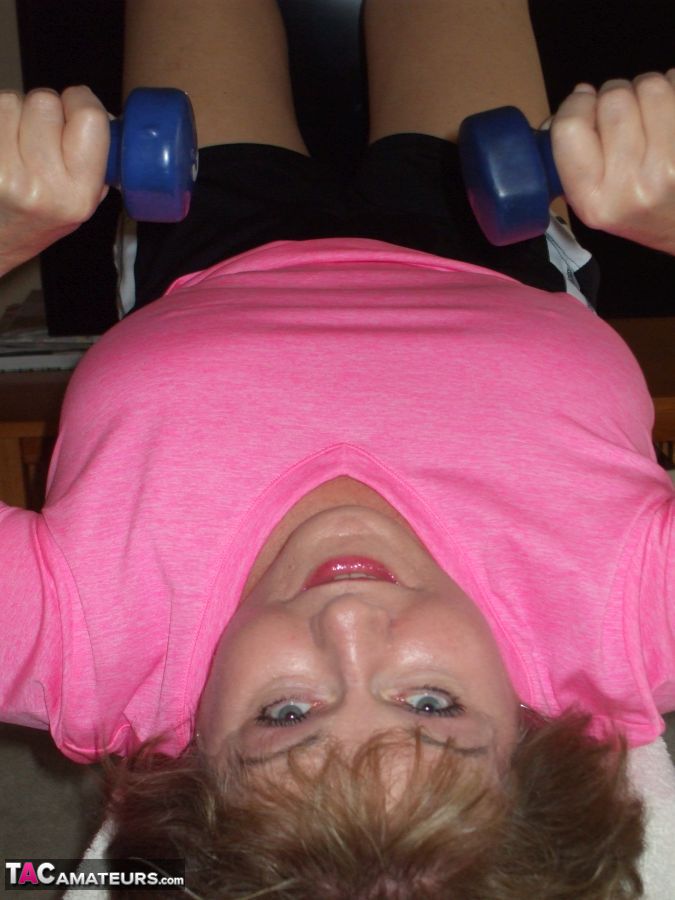 Mature woman Busty Bliss exposes her natural boobs while working out at home porn photo #428683805