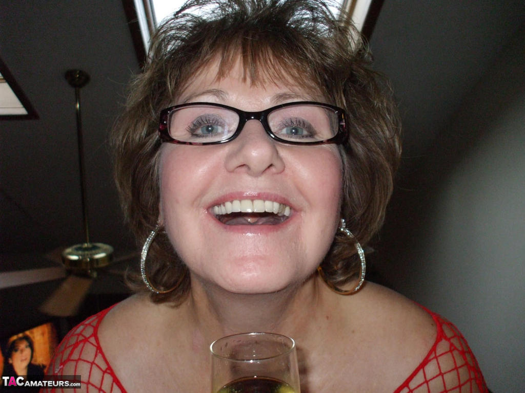 Mature Lady In A Fishnet Dress And Glasses Drinks Wine Before Stroking Cock