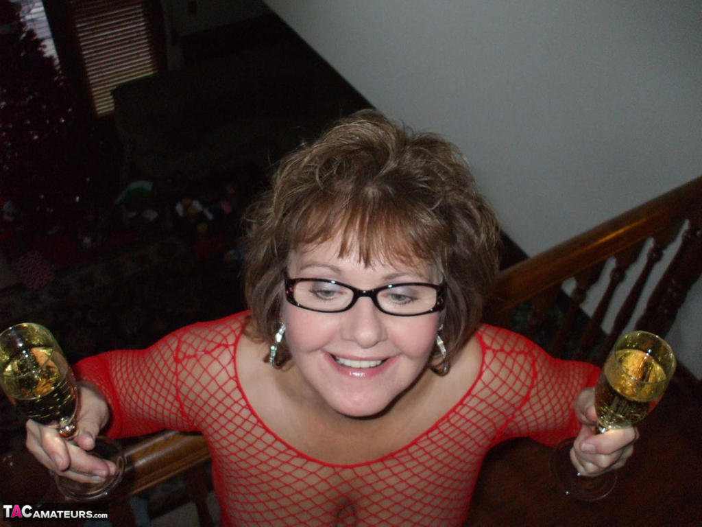 Mature Lady In A Fishnet Dress And Glasses Drinks Wine Before Stroking Cock