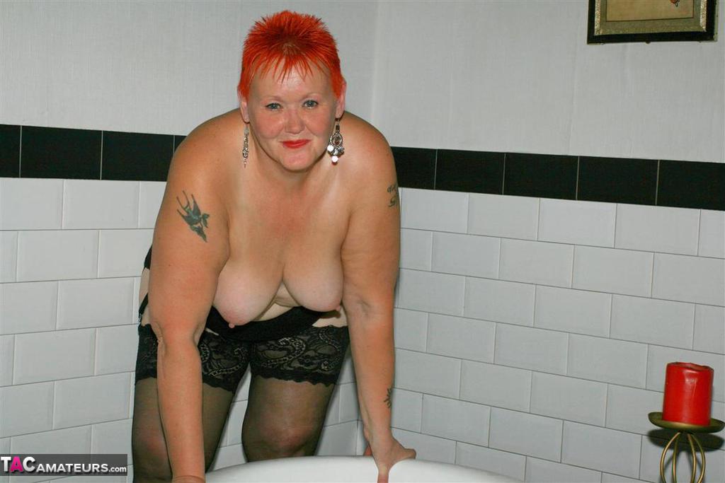 Older redhead Valgasmic Exposed models on the side of a claw tub in hosiery photo porno #425430137