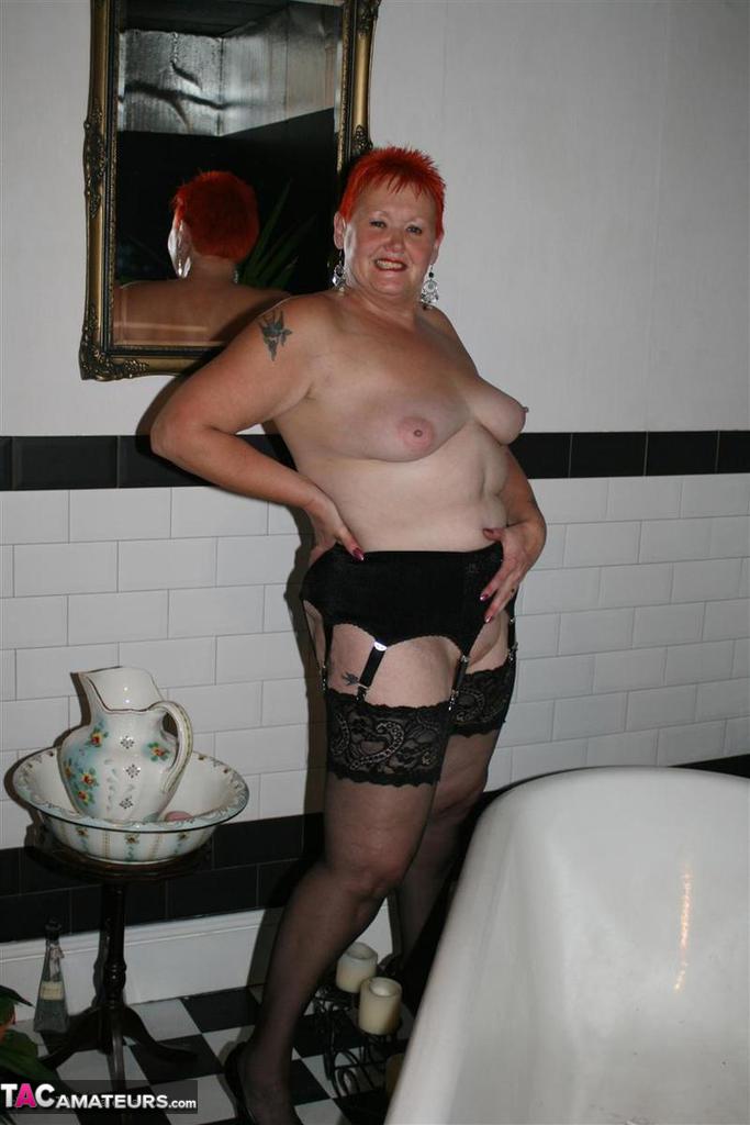 Older redhead Valgasmic Exposed models on the side of a claw tub in hosiery porno foto #425430153