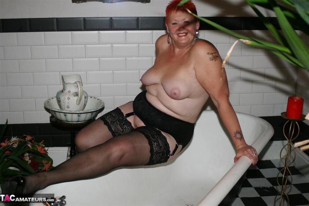 Older redhead Valgasmic Exposed models on the side of a claw tub in hosiery foto porno #425430157