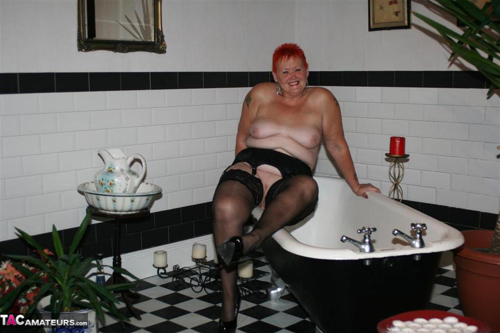 Older redhead Valgasmic Exposed models on the side of a claw tub in hosiery photo porno #425430183