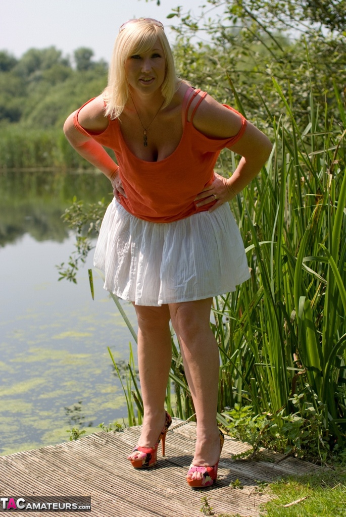 Fat blonde woman with large breasts Melody gets undressed on lakeside dock foto porno #425572674
