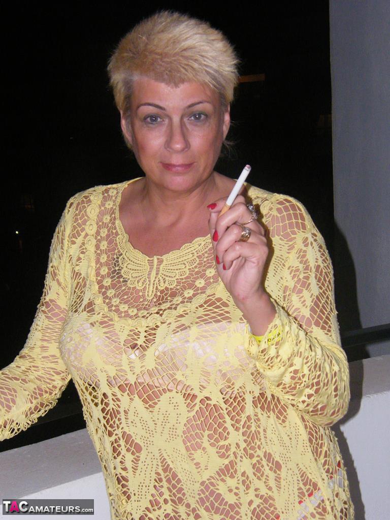 Middle-aged blonde Dimonty smokes while getting completely naked photo porno #426426021