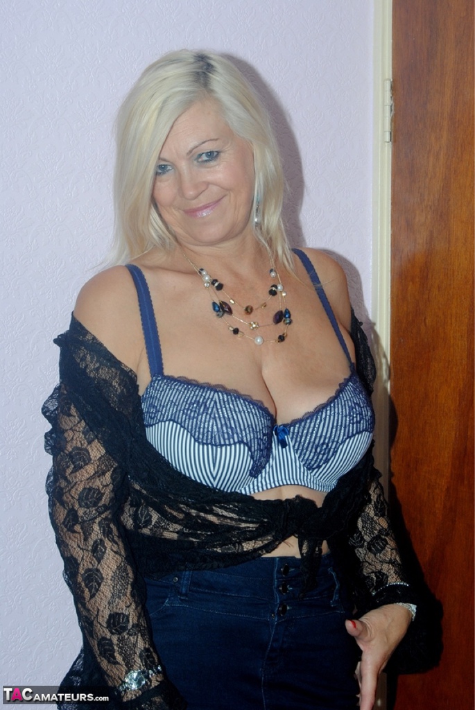 Older woman Platinum Blonde undressing to wear her seductive lace lingerie.