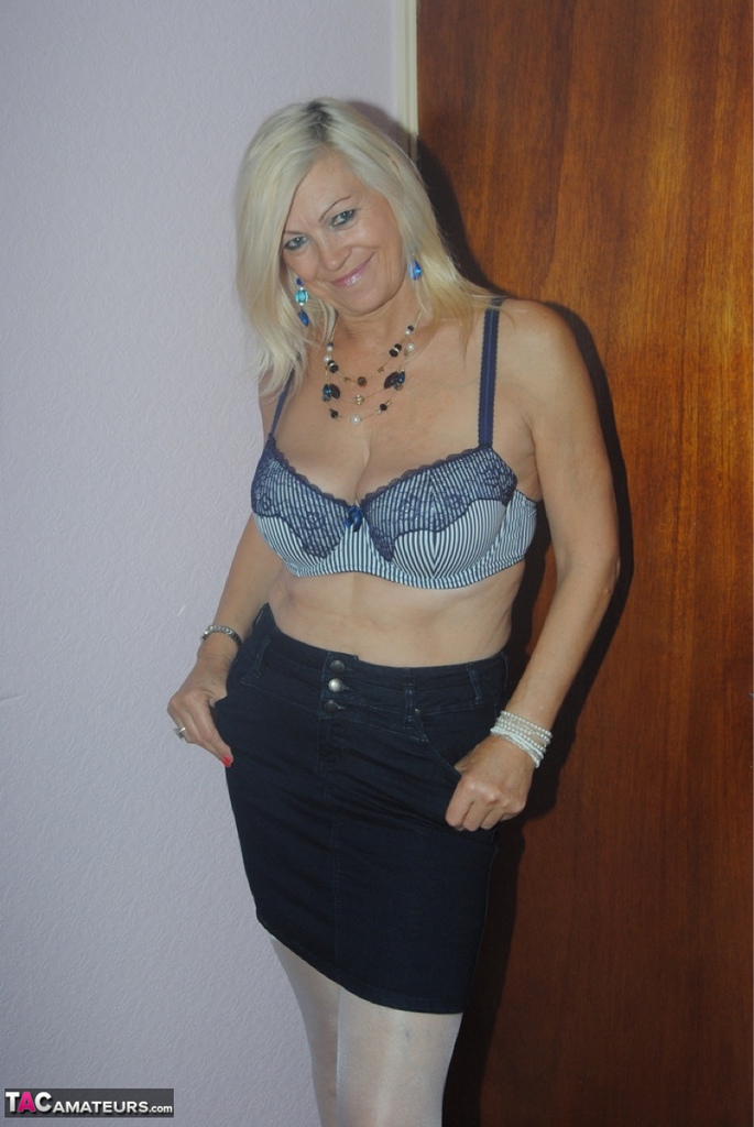 Platinum Blonde, who is older than she is, undressing to be seen in her seductive lace lingerie.