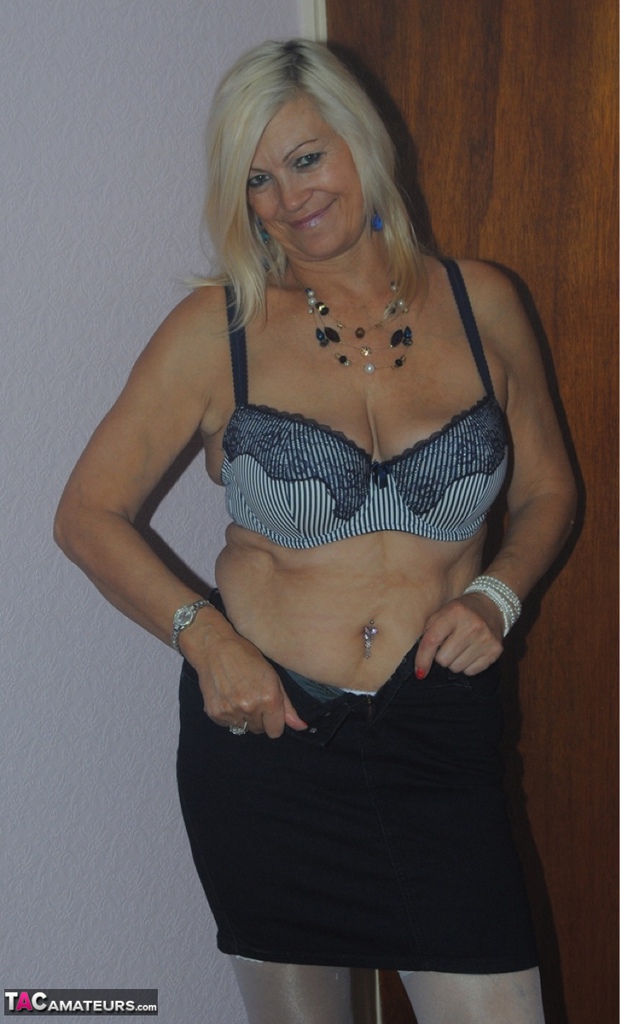 Older mature Platinum Blonde undressing to pose in her sexy lace lingerie