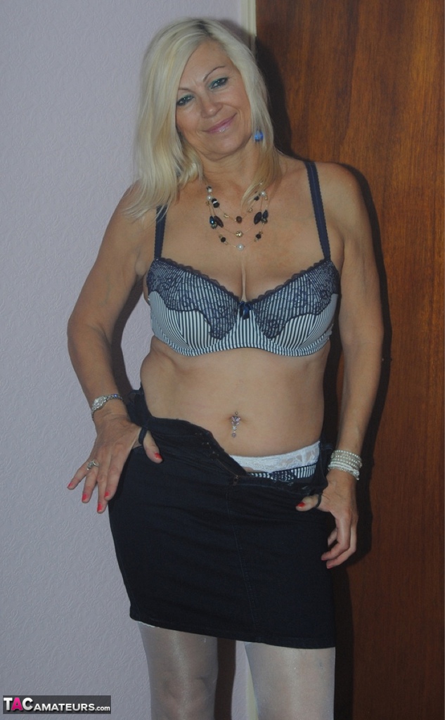 Older mature Platinum Blonde undressing to pose in her sexy lace lingerie