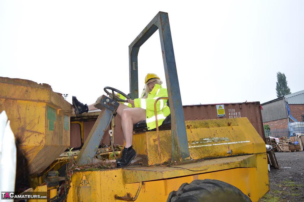 A job site where Barby Slut, a young performer, exposes herself on heavy equipment.