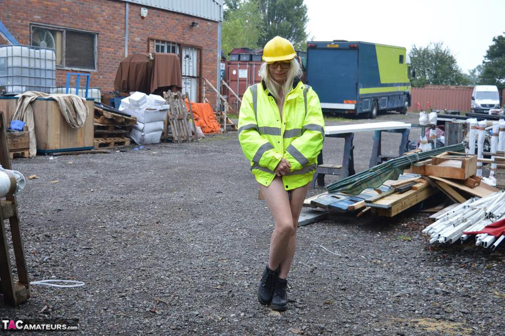The adult Barby Slut bares her figure on heavy equipment during an outdoor activity.