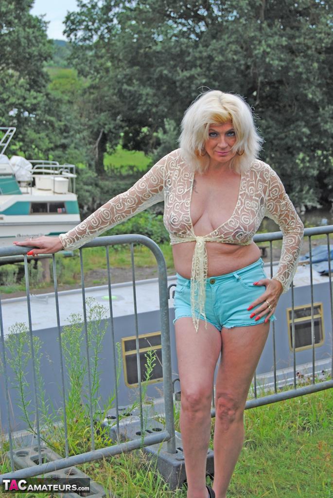 Mature slut Dimonty unveils floppy boobs in shorts & thong at the campground porno foto #428596077