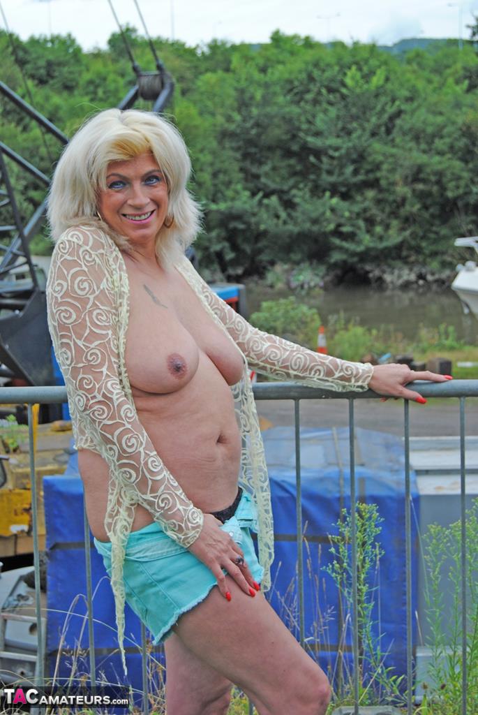 Mature slut Dimonty unveils floppy boobs in shorts & thong at the campground porno foto #428596081