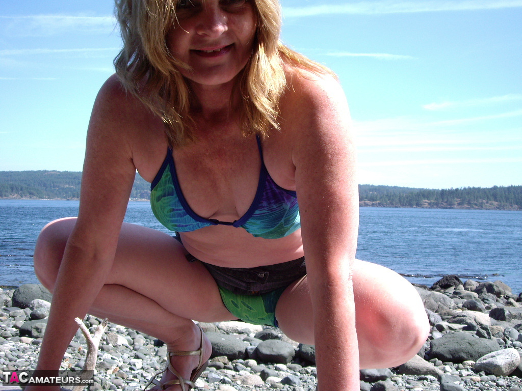 Middle-aged amateur Cougar Babe Lolee removes her bikini on a rocky shoreline porn photo #424891888