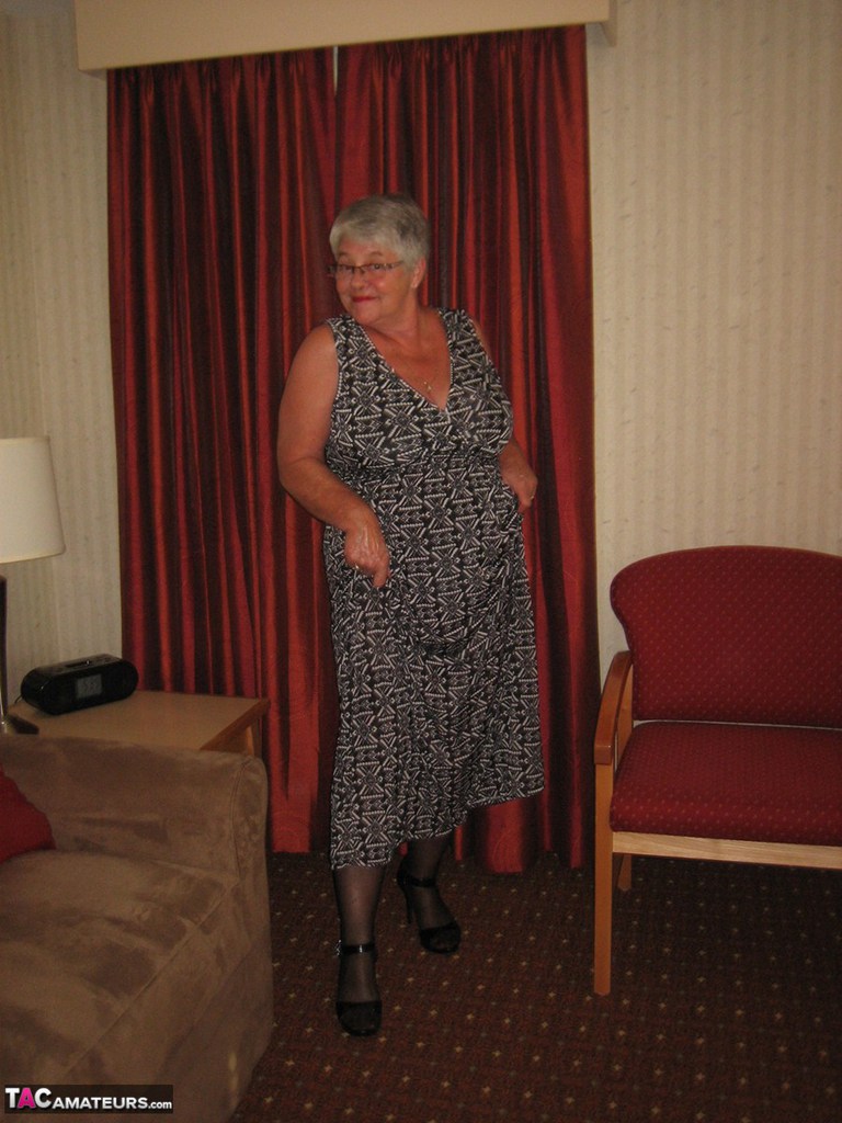 Fat Granny Girdle Goddess wears a black slip and girdle with her no panty upskirt.