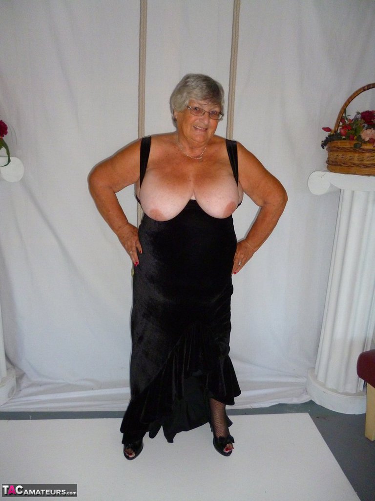 In stockings, Grandma Libby models herself in a black dress.