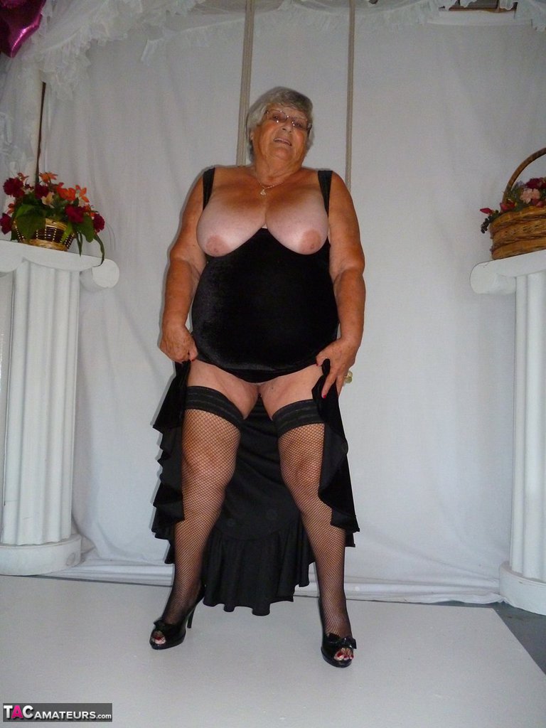 Fat grandmother Grandma Libby models herself in stockings wearing only black dresses.