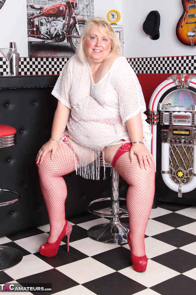 Overweight blonde Lexie Cummings gets naked in red fishnets inside a diner photo porno #428113556