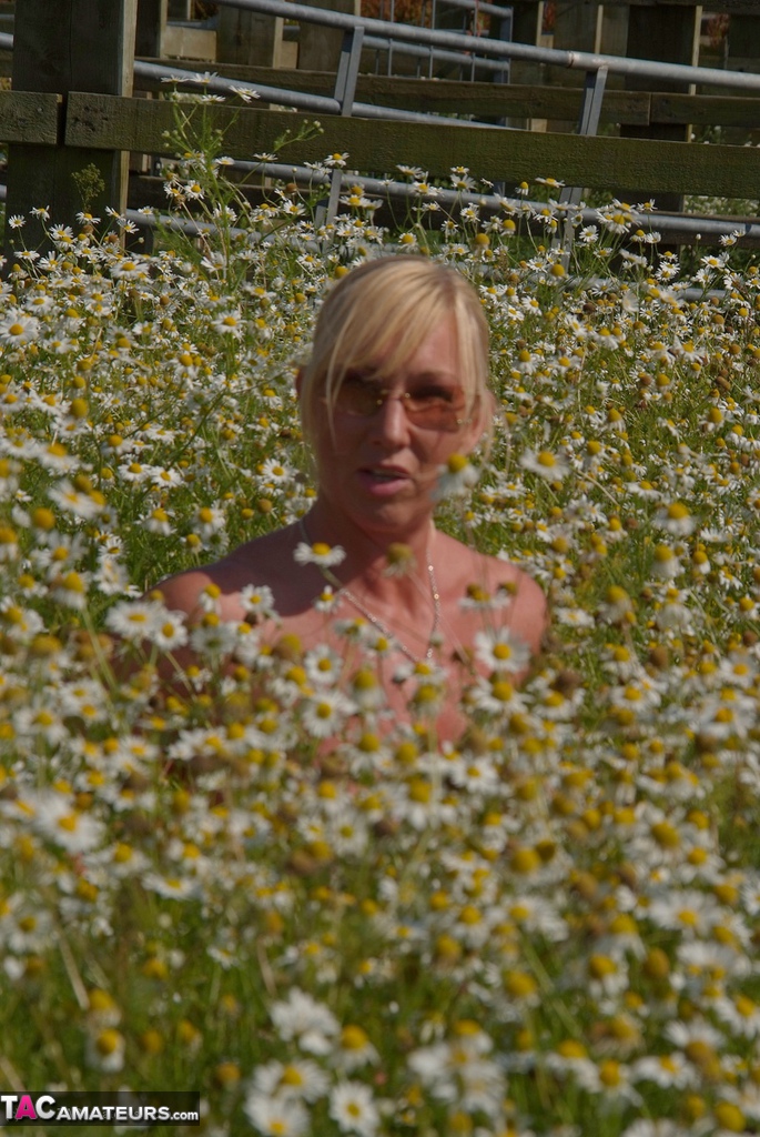 Overweight Blonde Melody Uncups Her Large Boobs In A Field Of Wild Flowers