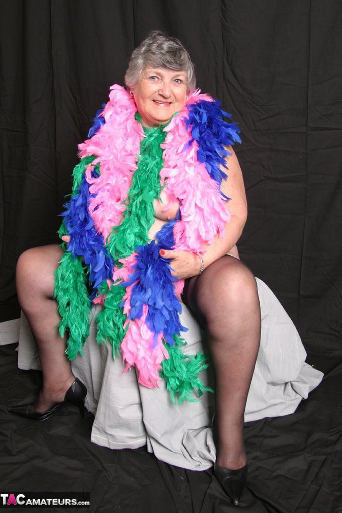 Fat UK amateur Grandma Libby drapes her big tits in feather boas.