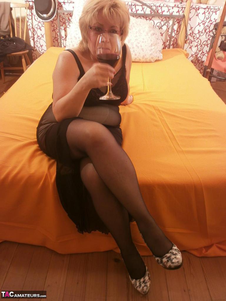 Tipsy Hot Granny Caro Spreading Legs On The Bed Wearing Black Stockings