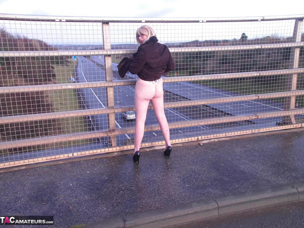A passerby spots Barby Slut, an older performer, flashing on a pavement while passing by.