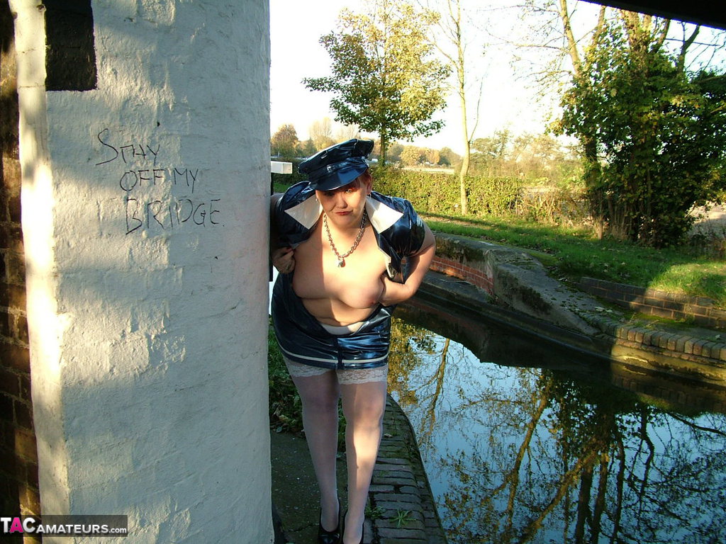 Older redhead Valgasmic Exposed exposes herself by a canal in a police uniform 포르노 사진 #428564110