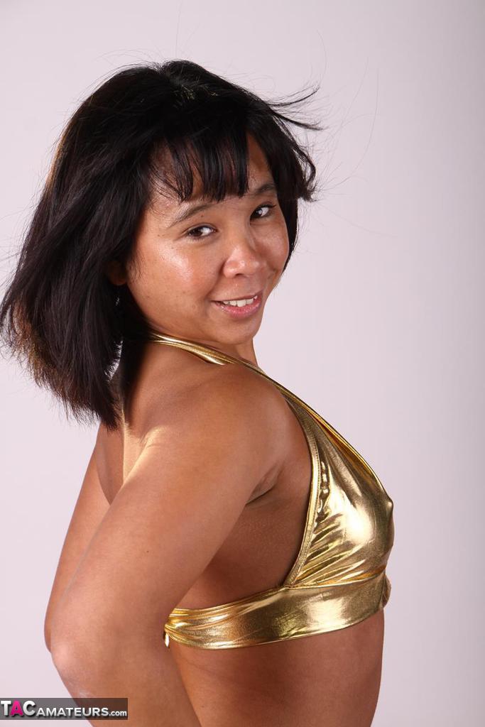 Asian amateur plays with her hair while modelling a gold outfit порно фото #427214117