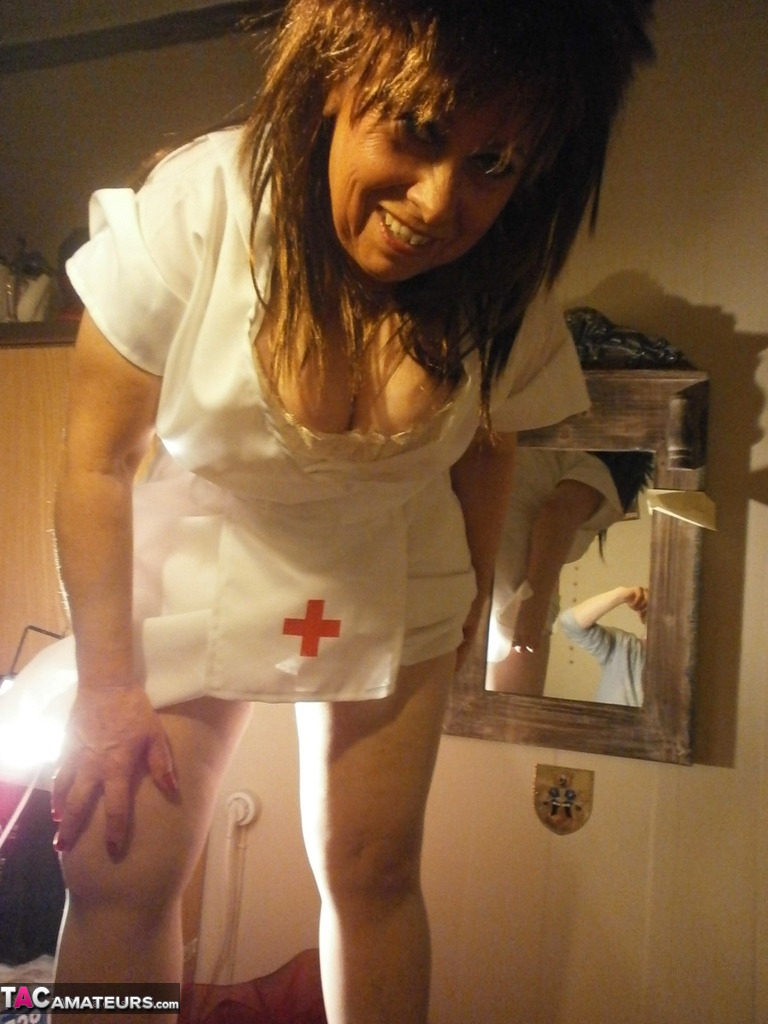 Older amateur Caro releases her breasts from her nurse uniform 포르노 사진 #428673250