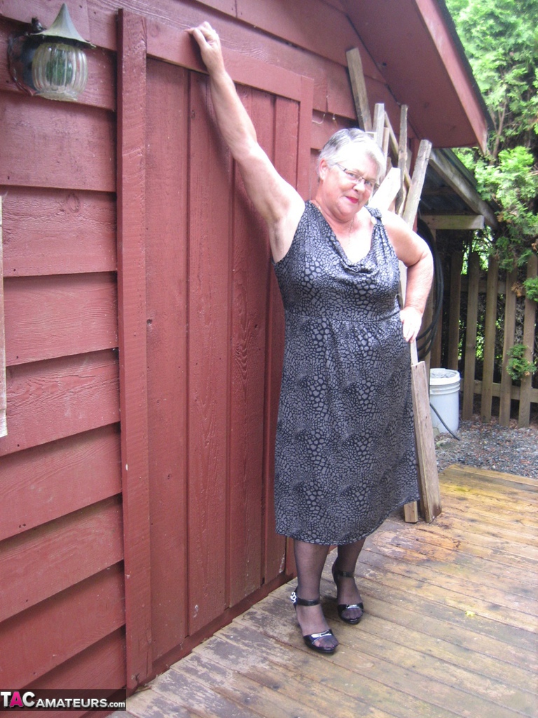 Fat Oma Girdle Goddess Unleashes Her Large Boobs Next To A Boarded Up Building