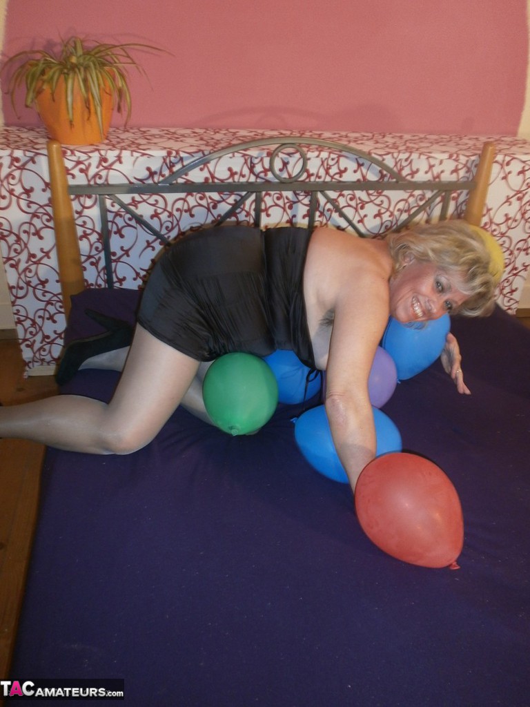 Hot Granny Caro In Shiny Sheer Pantyhose Heels Crushing Balloons On Her Bed