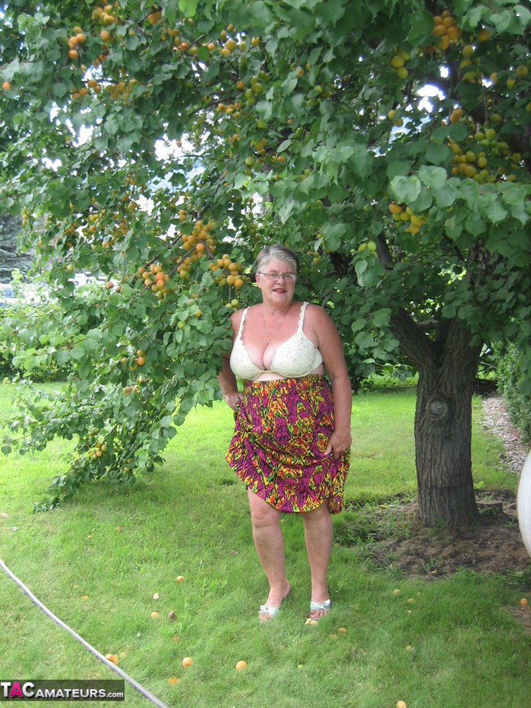 Fat granny Girdle Goddess exposes her large tits under a fruit bearing tree porn photo #425915572