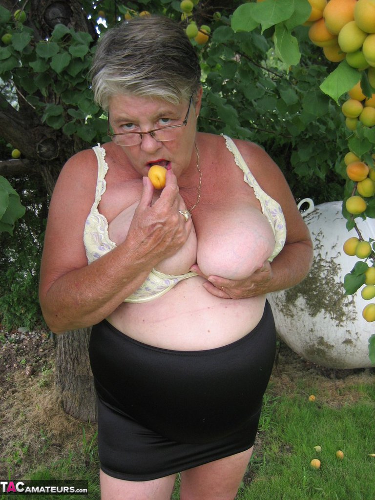 Fat granny Girdle Goddess exposes her large tits under a fruit bearing tree porn photo #425915596
