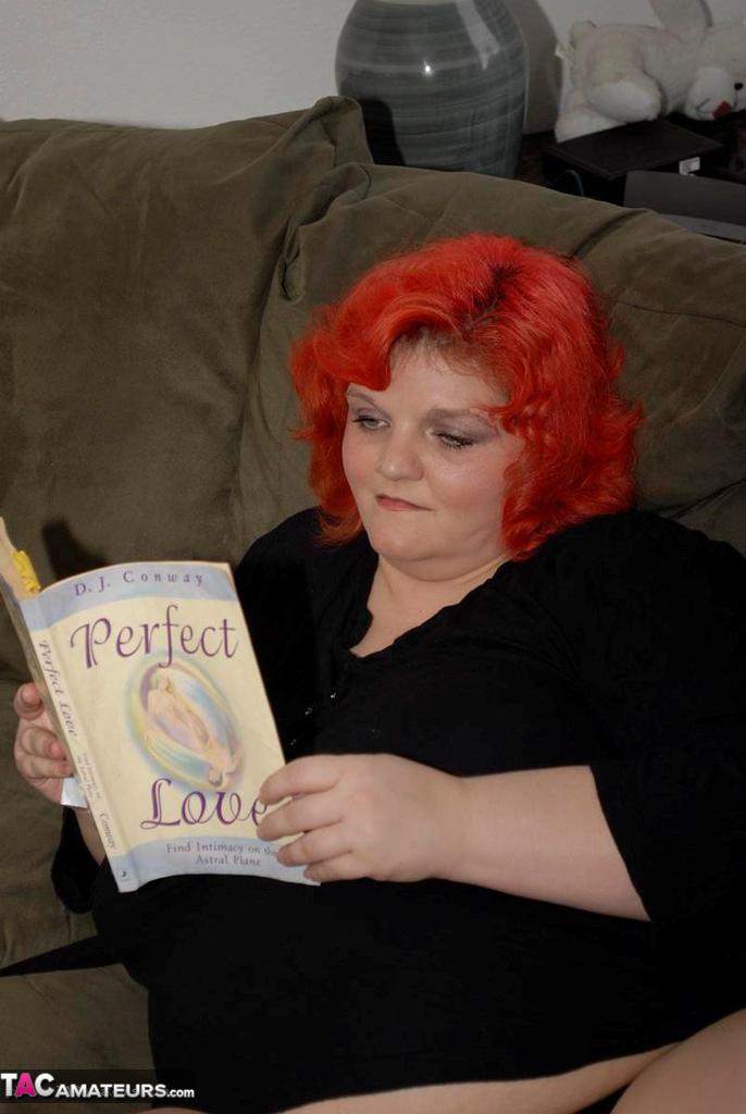 Obese older redhead Black Widow AK fondles herself while reading a romance porn photo #428140259
