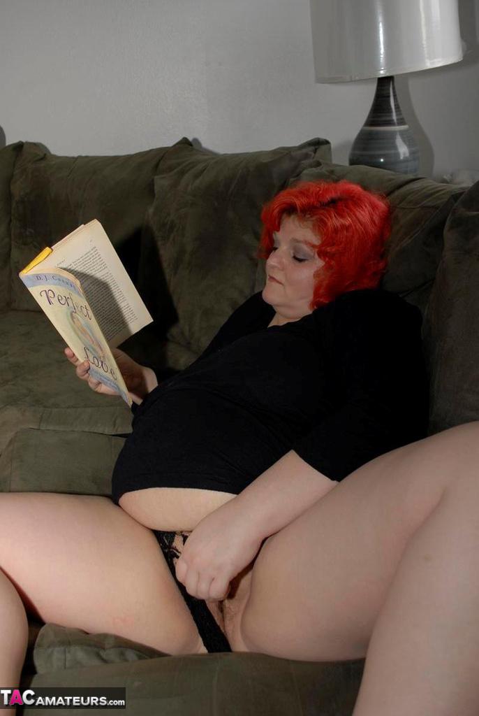Obese older redhead Black Widow AK fondles herself while reading a romance porn photo #428140262