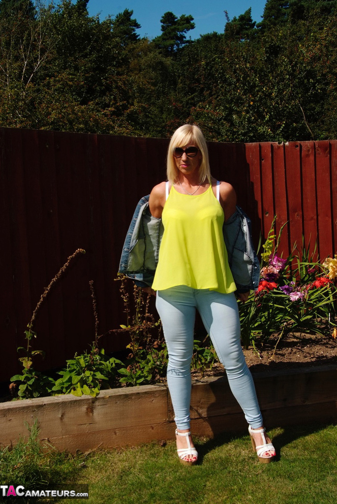Middle-aged blonde Melody models in a bra and faded jeans in a backyard photo porno #428537061