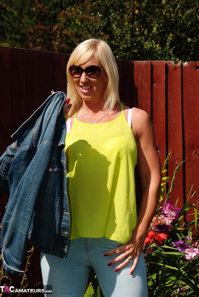 Middle-aged blonde Melody models in a bra and faded jeans in a backyard porno foto #428537064