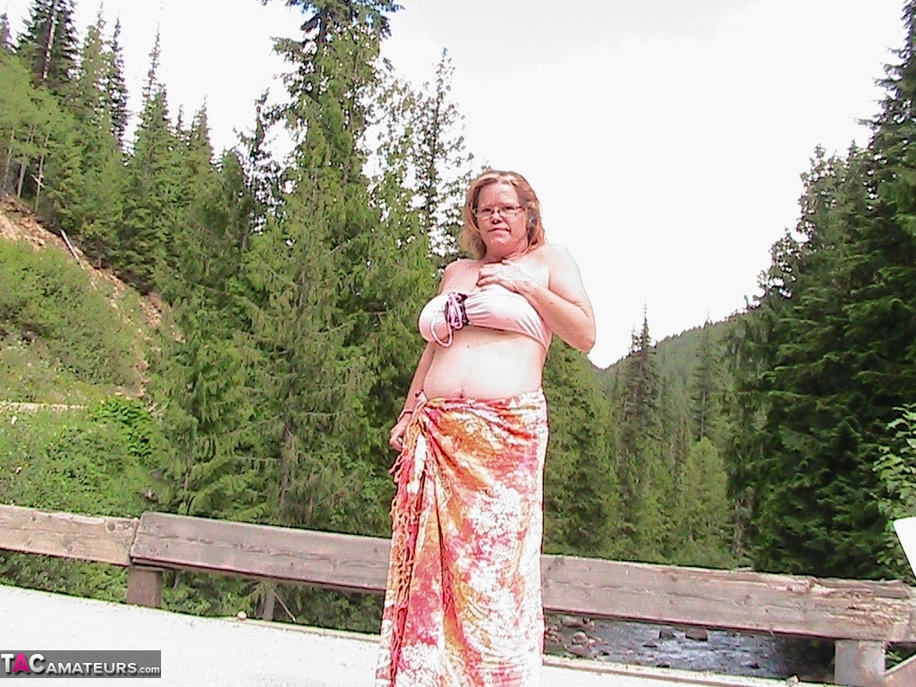 Busty granny Misha MILF exposes herself while on a bridge over top of a river photo porno #425370962