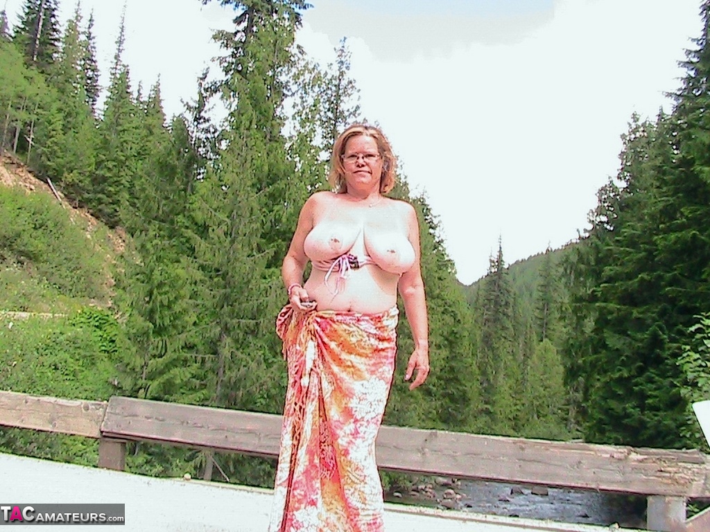 Busty granny Misha MILF exposes herself while on a bridge over top of a river photo porno #425370964