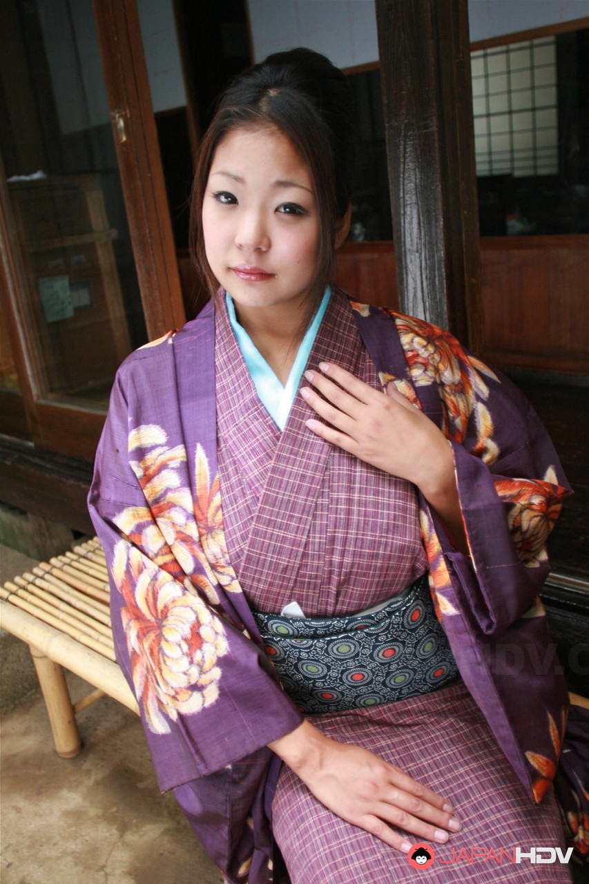 Wearing a no panty upskirt, a Japanese woman pulls up her kimono to wear on the patio.