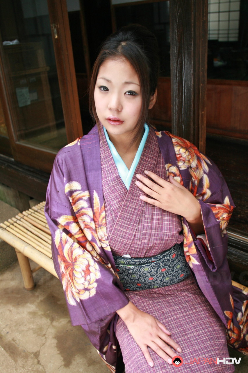 Wearing a no panty upskirt, the Japanese woman pulls her kimono from the patio.