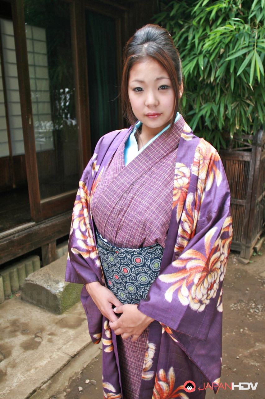 A Japanese woman puts on her kimono without a panty to wear on the patio.