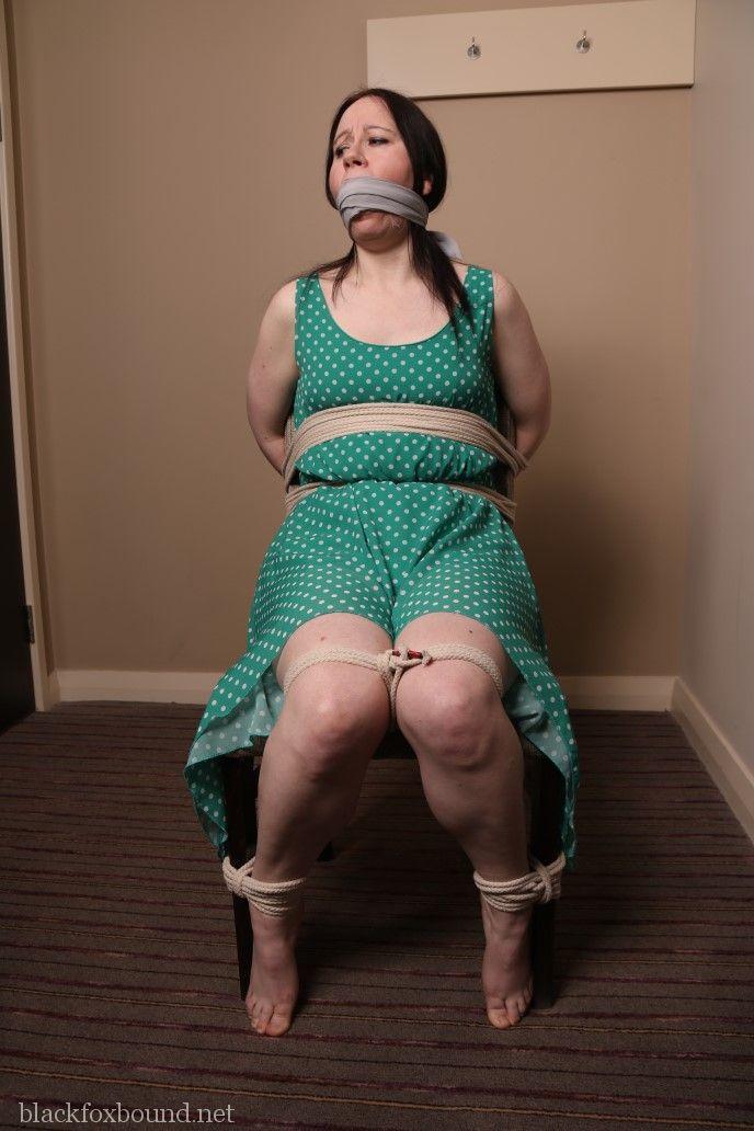 Distressed mature woman in polka-dot dress tied up & gagged for BDSM fun porn photo #428608000