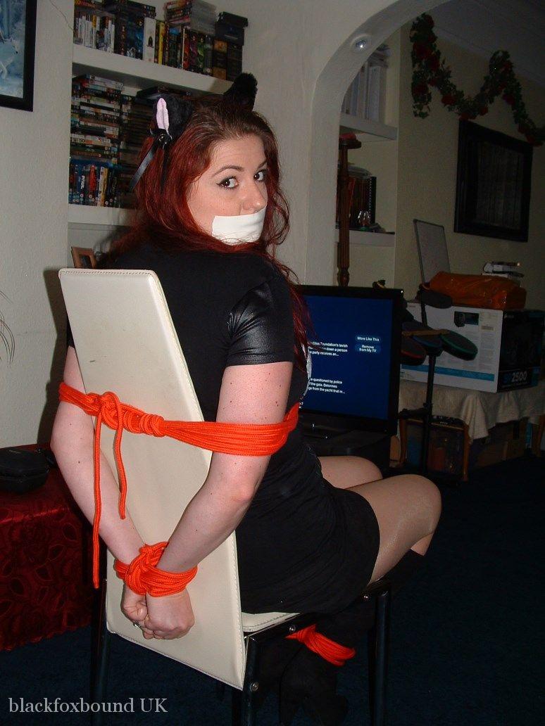 Thick redhead is tied to a chair with tape affixed to her mouth porn photo #429041170