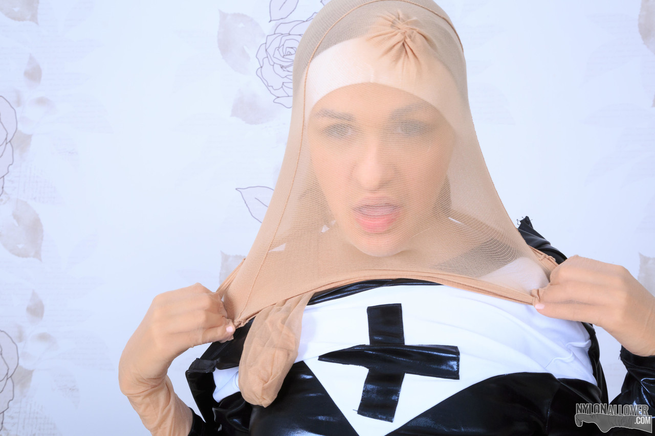 Naughty nun pulls pantyhose over her latex uniform and head foto porno #426123620