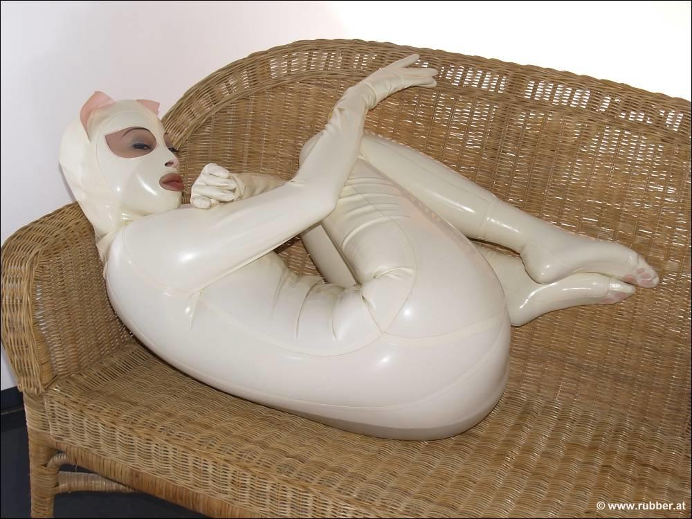 Females wearing rubber clothing model themselves in rubber during a solo engagement.