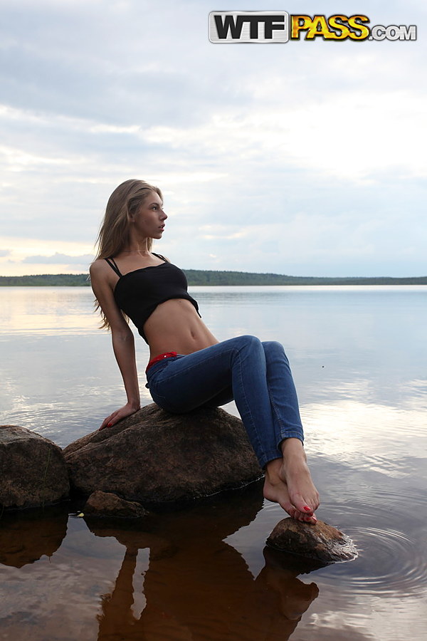 Girl next door Megan pulls out her tits while sitting on a rock in the lake porn photo #427190509