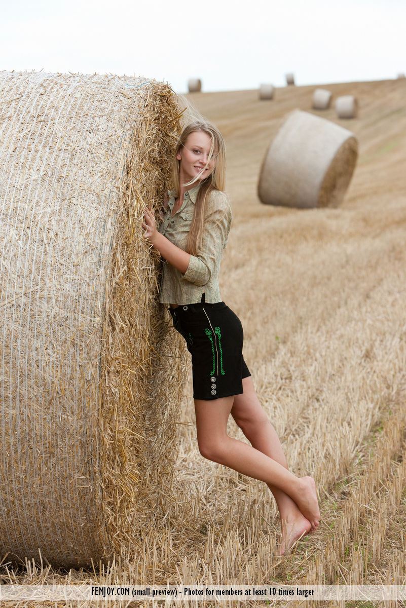 Beautiful blonde teen Carisha strips naked next to a round bale of hay porn photo #427824123