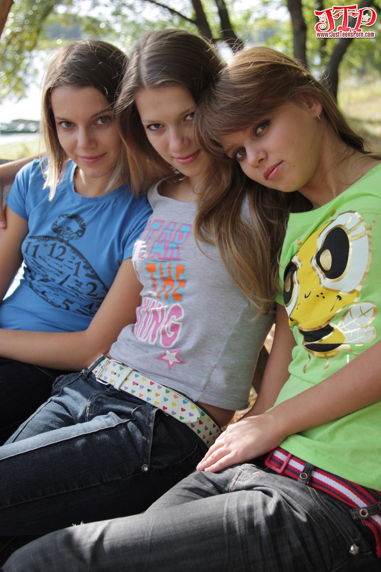 3 young girls remove T-shirts and jeans to model naked on park bench foto porno #423898900